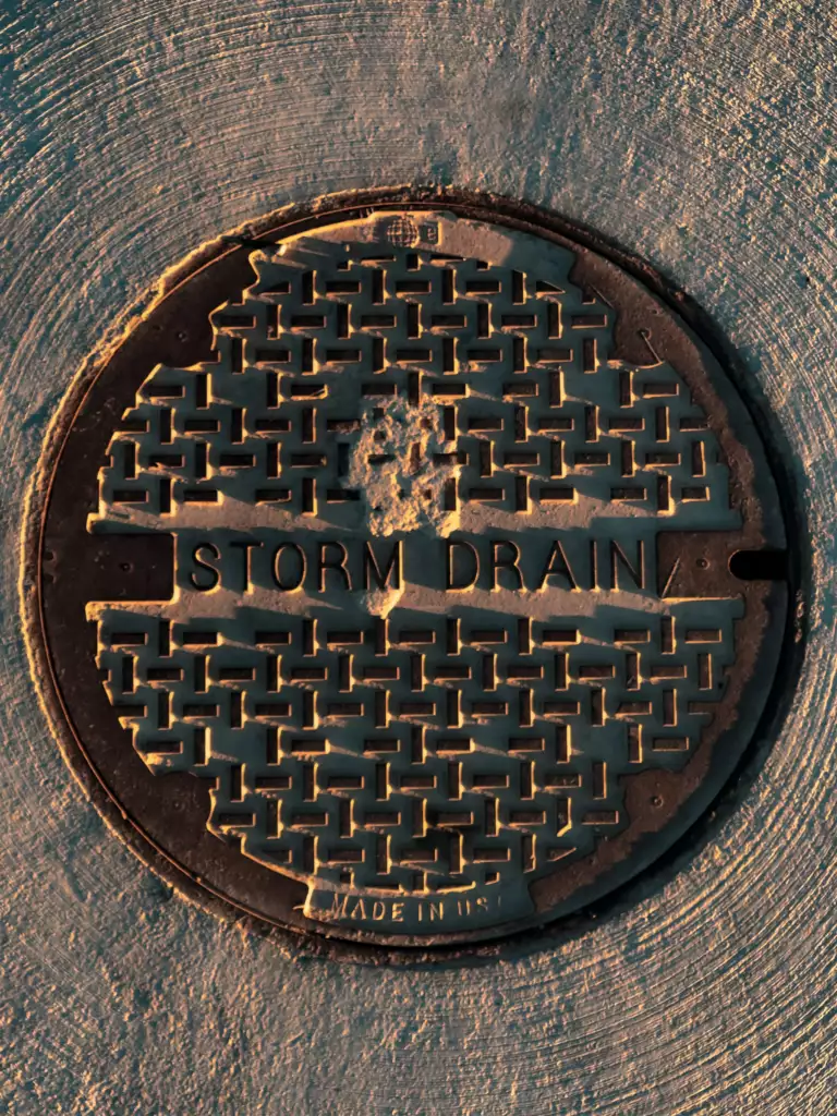 Black and Brown man hole cover of a sewer