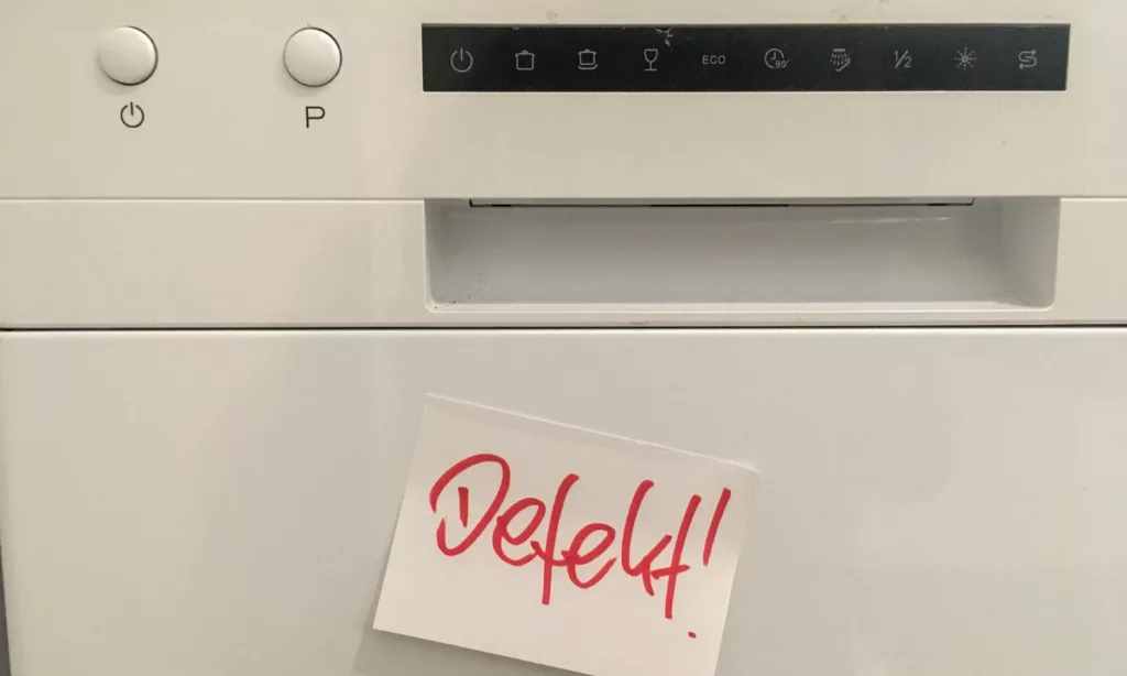 Dishwasher that has a post it note saying defect on it